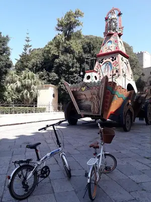 two bikes are parked in front of a truck at Piazza Marina in Palermo
