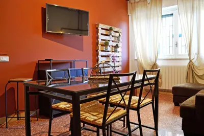 a living room with a table and chairs and a tv at Piazza Marina in Palermo