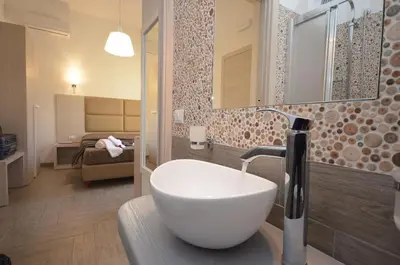 a bathroom with a white sink and a room at B&B Timpe Bianche in Castelluzzo