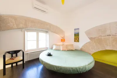 a bedroom with a large bed and a window at Gattopardo Apartments - LAGO Design by Wonderful Italy in Palermo
