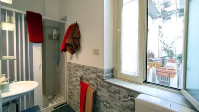 a bathroom with a sink and a window at Appartamenti Olivuzza in Palermo