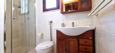 a bathroom with a sink and a toilet and a shower at Villa Paradiso in Alcamo Marina