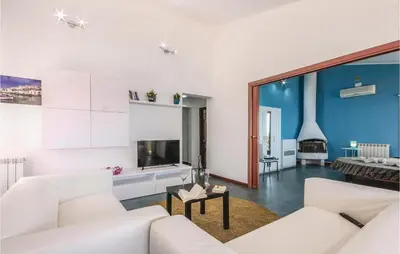 a living room with white furniture and a blue wall at Villa Belvedere in Castellammare del Golfo