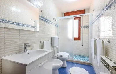 a white bathroom with a sink and a toilet at Villa Belvedere in Castellammare del Golfo