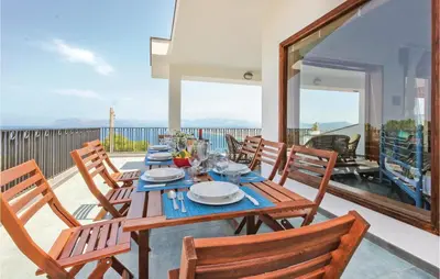 a dining room with a table and chairs on a balcony at Villa Belvedere in Castellammare del Golfo