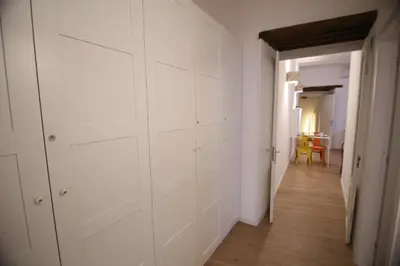 a hallway with white closets in a room at Bedda Mari Rooms & Suite in Palermo