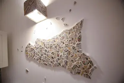 a painting of a map on a wall with a light at Bedda Mari Rooms & Suite in Palermo