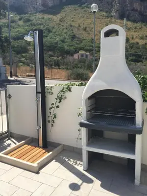 a pizza oven sitting on top of a roof at Casa Azzurra by Un mare di Blu in Macari