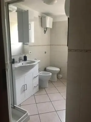 a bathroom with a toilet and a sink and a mirror at Le Terrazze sul Mare - Capo Aranciotto Beach in Cefalù
