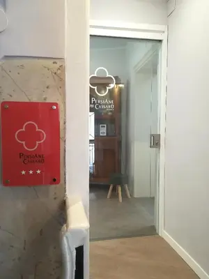 a door leading into a room with a sign on the wall at Persiane al Cassaro in Palermo