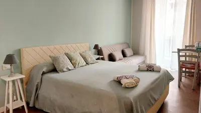 a bedroom with a large bed and a couch at Persiane al Cassaro in Palermo