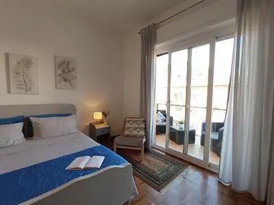 a bedroom with a bed and a large sliding glass door at Casa del Cioccolato in Palermo