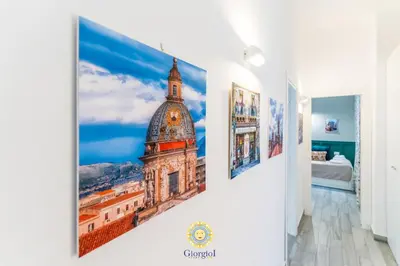 a room with a picture of a building on the wall at Giorgio I rooms in Palermo
