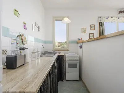 a kitchen with a counter top and a stove at Apartment Cicladi Tinos by Interhome in Santa Flavia