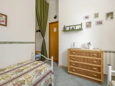 a bedroom with a bed and a dresser at Apartment Cicladi Tinos by Interhome in Santa Flavia