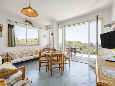 a living room with a table and chairs and a large window at Apartment Cicladi Tinos by Interhome in Santa Flavia