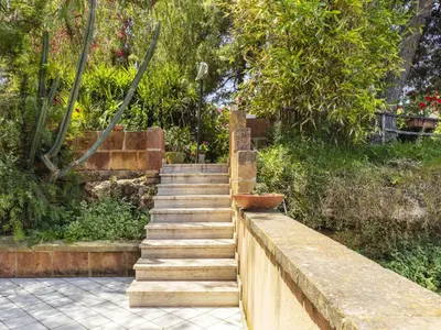 a set of stone stairs in a garden at Apartment Cicladi Milos by Interhome in Santa Flavia