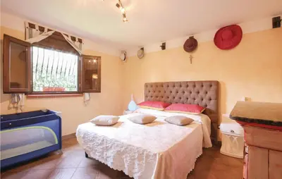a bedroom with a large bed and a sink at Villa Tourig Beach in Mandra Capreria