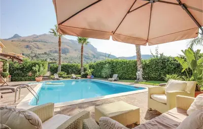 a swimming pool with chairs and an umbrella at Villa Tourig Beach in Mandra Capreria