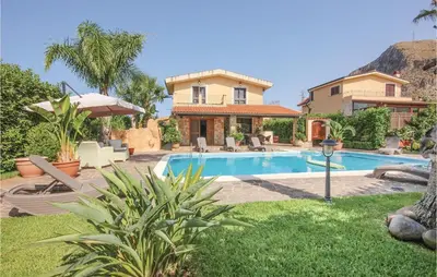 a house with a swimming pool in a yard at Villa Tourig Beach in Mandra Capreria