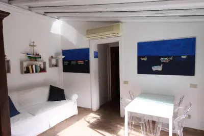 a living room with a white couch and a table at Ciuri Ciuri Mondello in Mondello