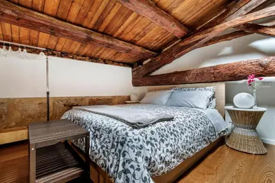 a bedroom with a bed and a wooden ceiling at La Suite del Principe con parcheggio incluso in Palermo