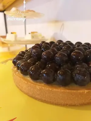 a blueberry pie sitting on a yellow table at B&B L'Officina di Apollo in Mondello