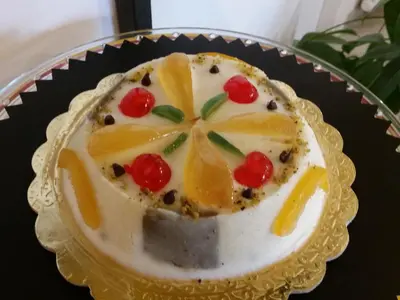 a cake with fruit on a plate on a table at B&B L'Officina di Apollo in Mondello