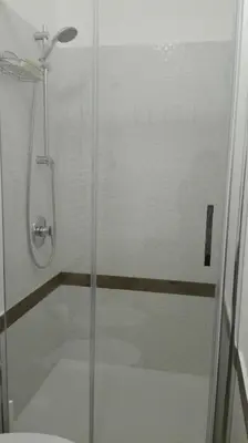 a shower with a glass door in a bathroom at Demetra Rooms in Palermo