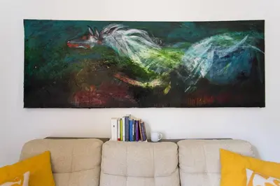 a painting hanging above a couch in a living room at Le Luminarie - Creative Residence in Balestrate