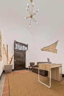 a living room with a couch and a table at Voilà Rooms Guest House in Terrasini