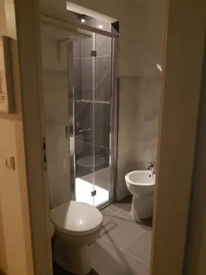 a bathroom with a shower and a toilet and a sink at Ruggero Settimo Gallery in Palermo