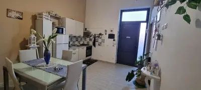 a kitchen with a table and a blue door at A Casa Di Lilly in Palermo
