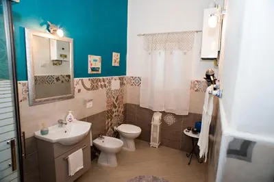 a bathroom with a toilet and a sink at A Casa Di Lilly in Palermo