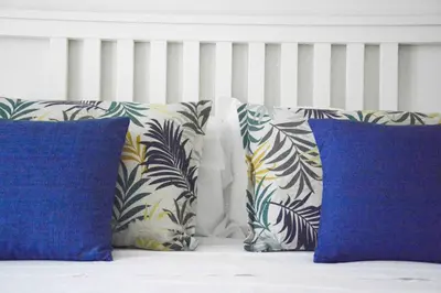a group of pillows sitting on top of a bed at Villa Almyra in San Vito lo Capo