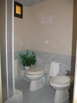 a bathroom with a toilet and a sink at Nonna Giò House in Castellammare del Golfo