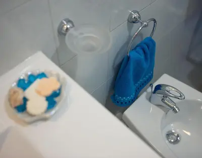a bathroom with a sink and a bowl of toiletries at Light Blue in Balestrate
