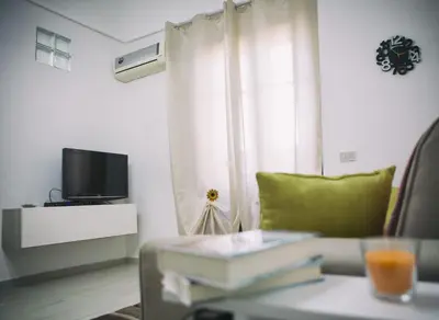 a living room with a couch and a tv at Light Blue in Balestrate