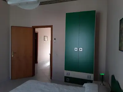a bedroom with a green cabinet and a bed at Elimo Affittacamere - Casa Vacanze di Scardino Leonardo in Poggioreale
