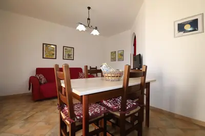 a kitchen with a counter and a table with chairs at casa Vincenzo in Castelluzzo