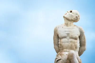 a statue of a man sitting on the ground at Palazzo Planeta in Palermo