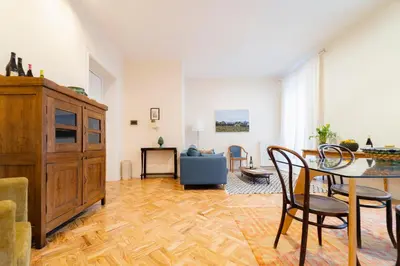 a living room with a table and chairs and a couch at Palazzo Planeta in Palermo