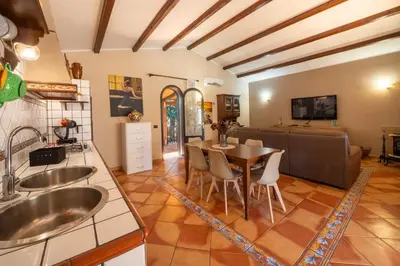 a kitchen and dining room with a table and chairs at Villa Eden con piscina a Scopello in Castellammare del Golfo