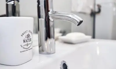a white coffee mug sitting on a bathroom sink at Palermo al Centro - Appartamento Maestri in Palermo