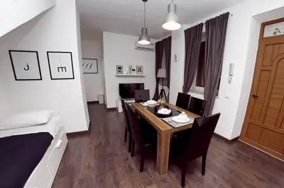 a room with a table and chairs and a bed at Palermo al Centro - Appartamento Maestri in Palermo