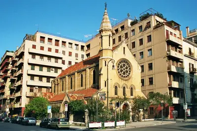 a church with a tower in front of a building at I Cinque Continenti in Palermo