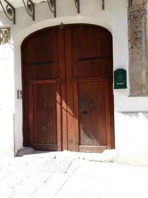 a large wooden door in the side of a building at BB45 in Palermo