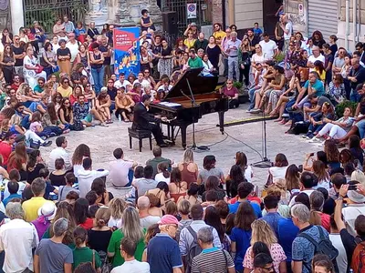 a man playing a piano in a crowd of people at BB45 in Palermo