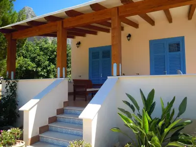 a house with blue shutters and stairs at Villa Ancora Bed & Breakfast in San Vito lo Capo