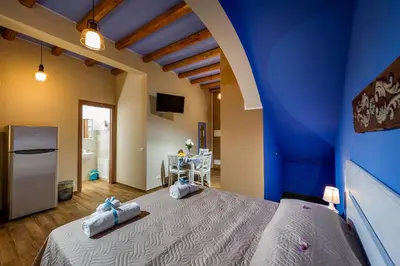 a bedroom with a blue wall and a bed at Antico Canale in Castellammare del Golfo